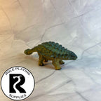 A dnd miniature ankylosaurus painted.
