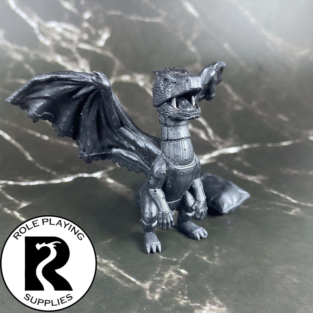 A dnd miniature bed dragon wyrmling primed in black.
