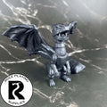 A dnd miniature bed dragon wyrmling primed in black.

