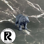 A dnd miniature black bear primed in black.
