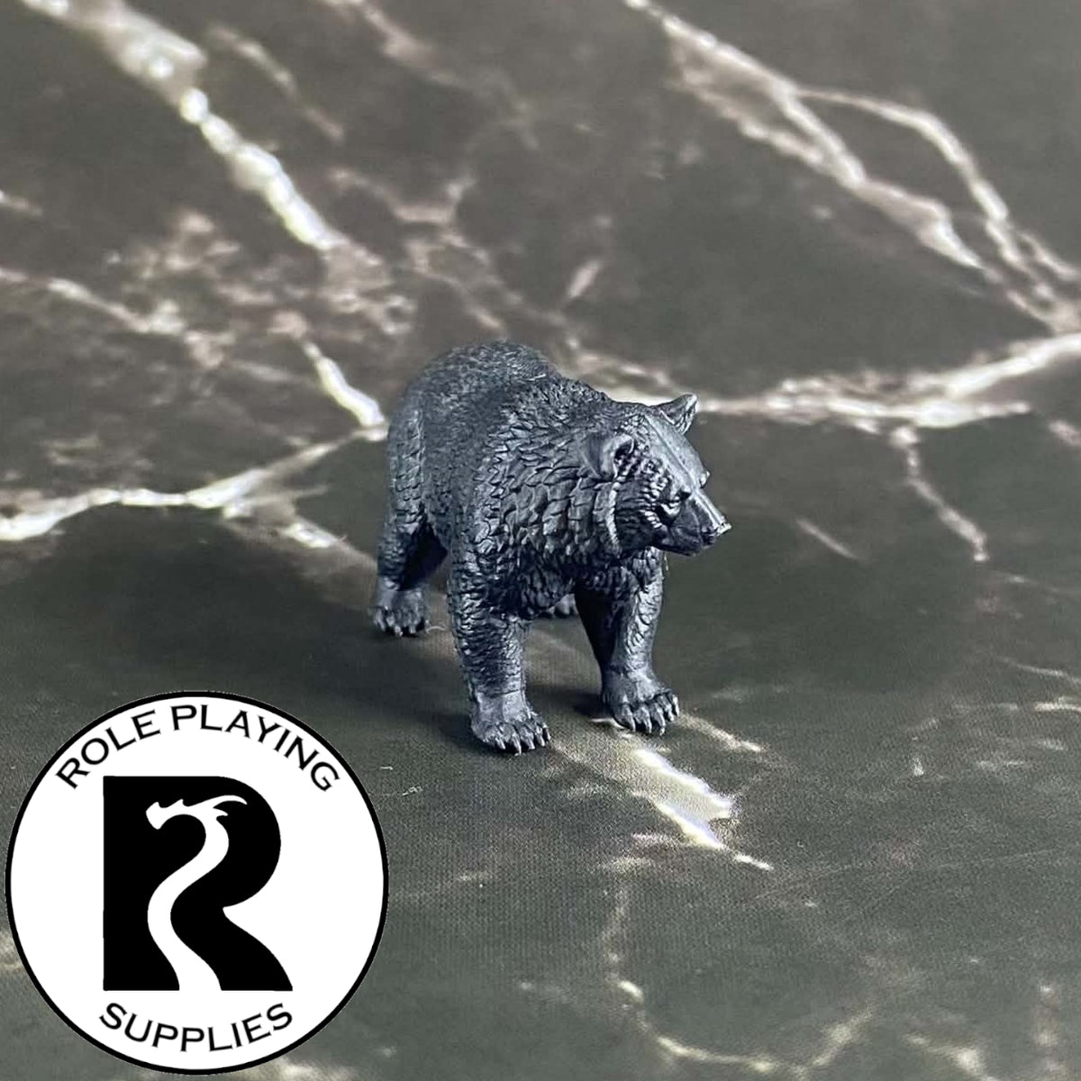 A dnd miniature black bear primed in black.
