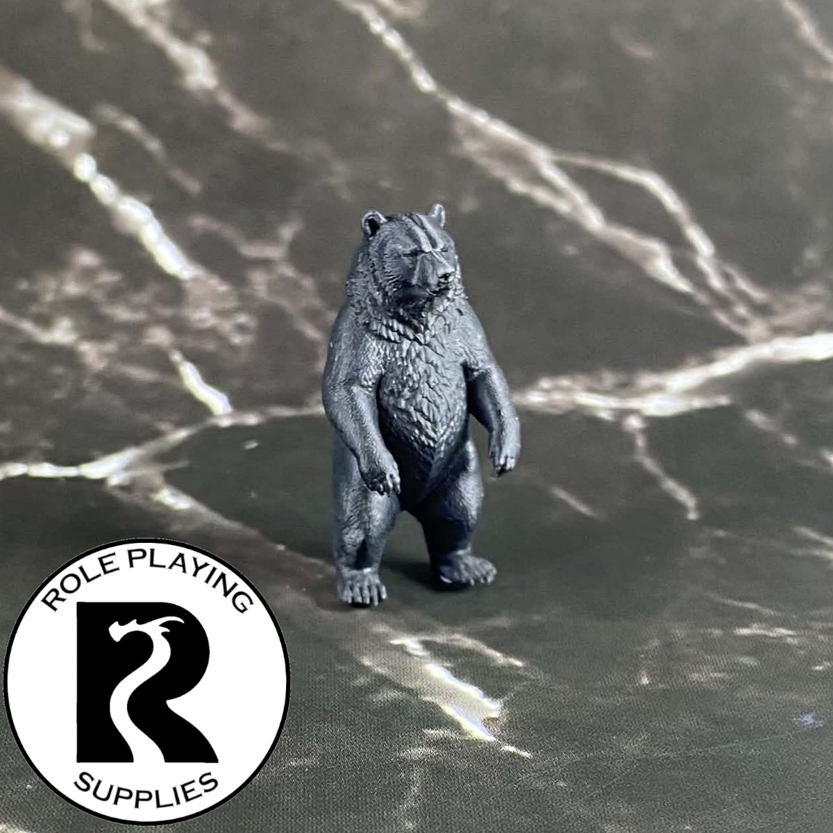 A dnd miniature black bear primed in black.
