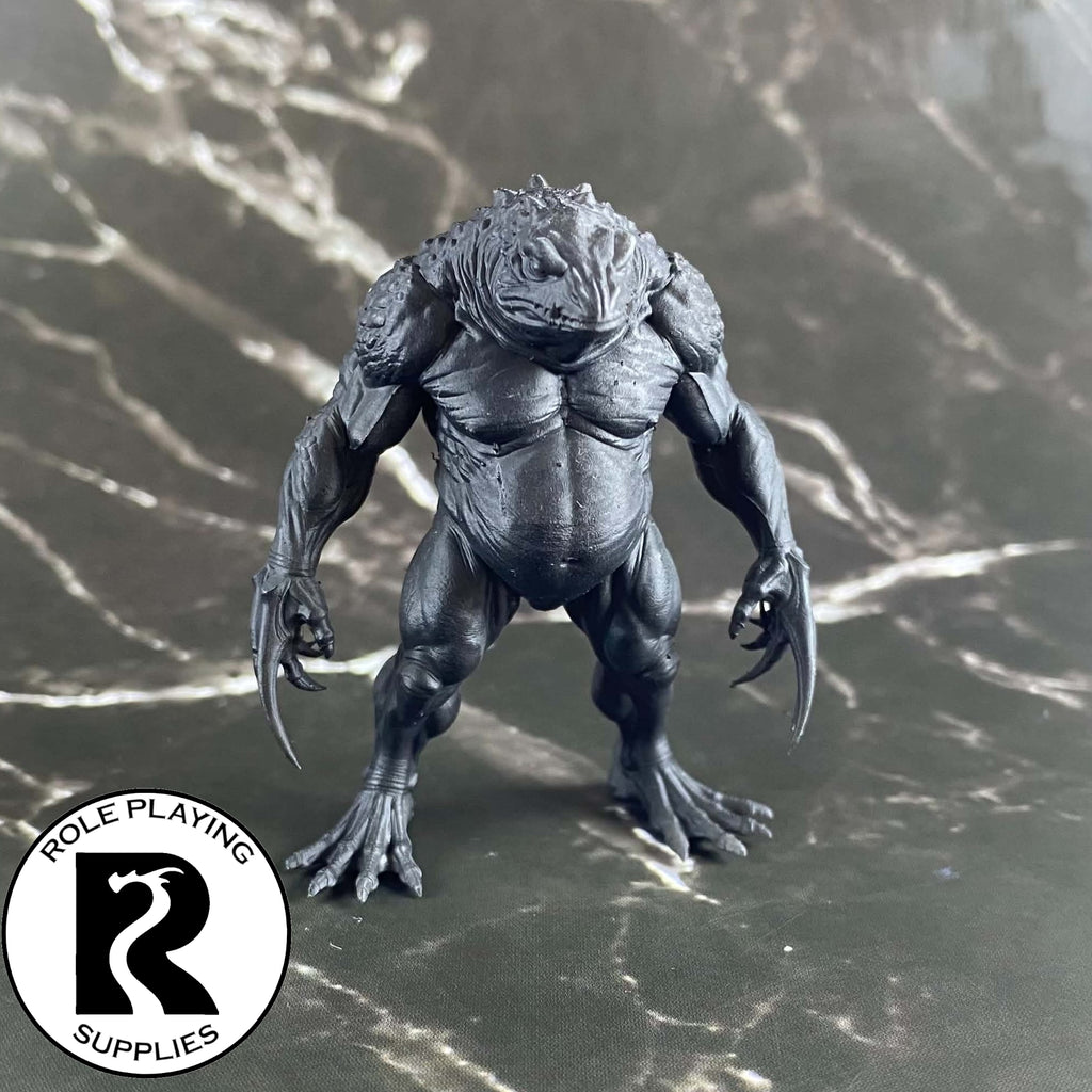 A dnd miniature blue slaad primed in black.

