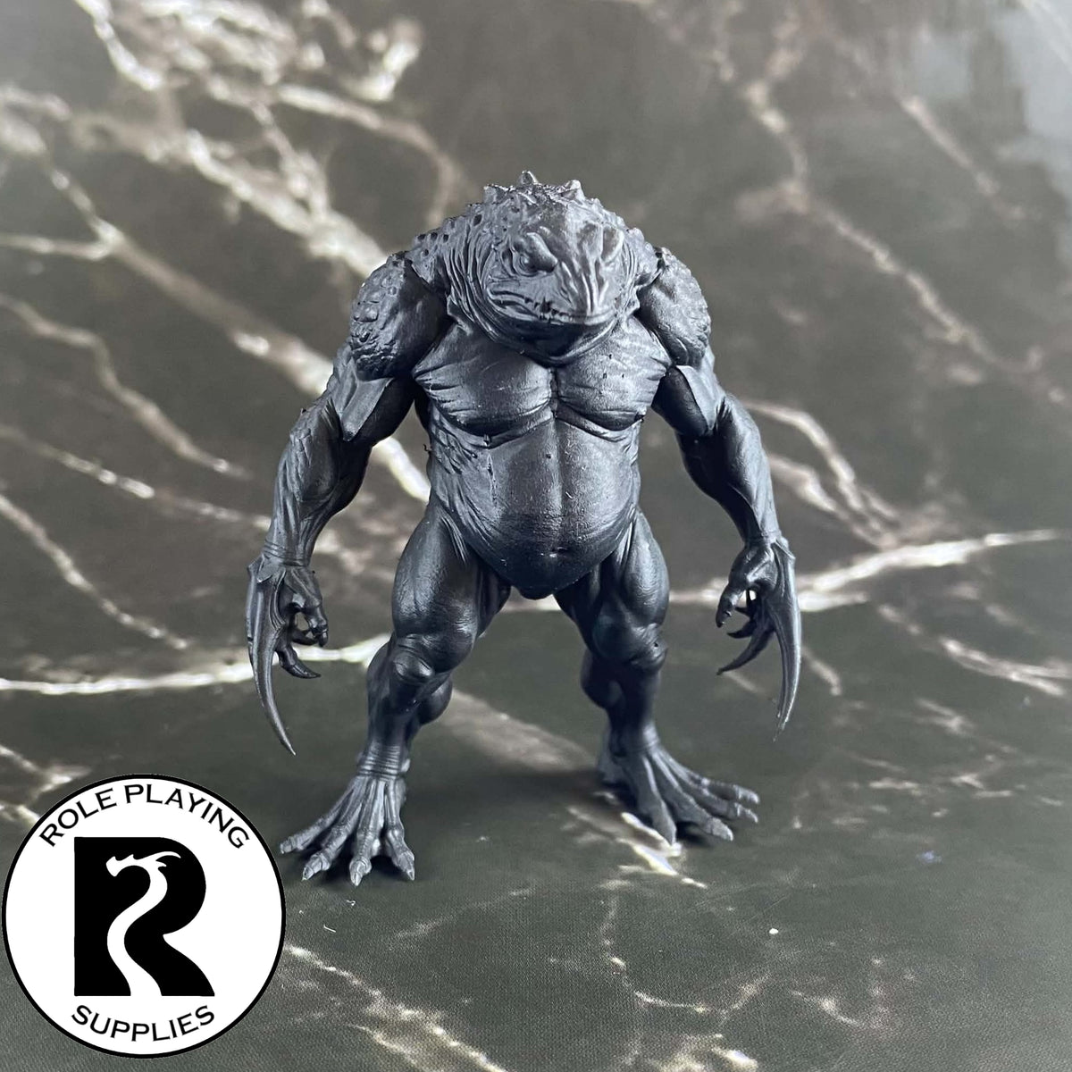 A dnd miniature blue slaad primed in black.
