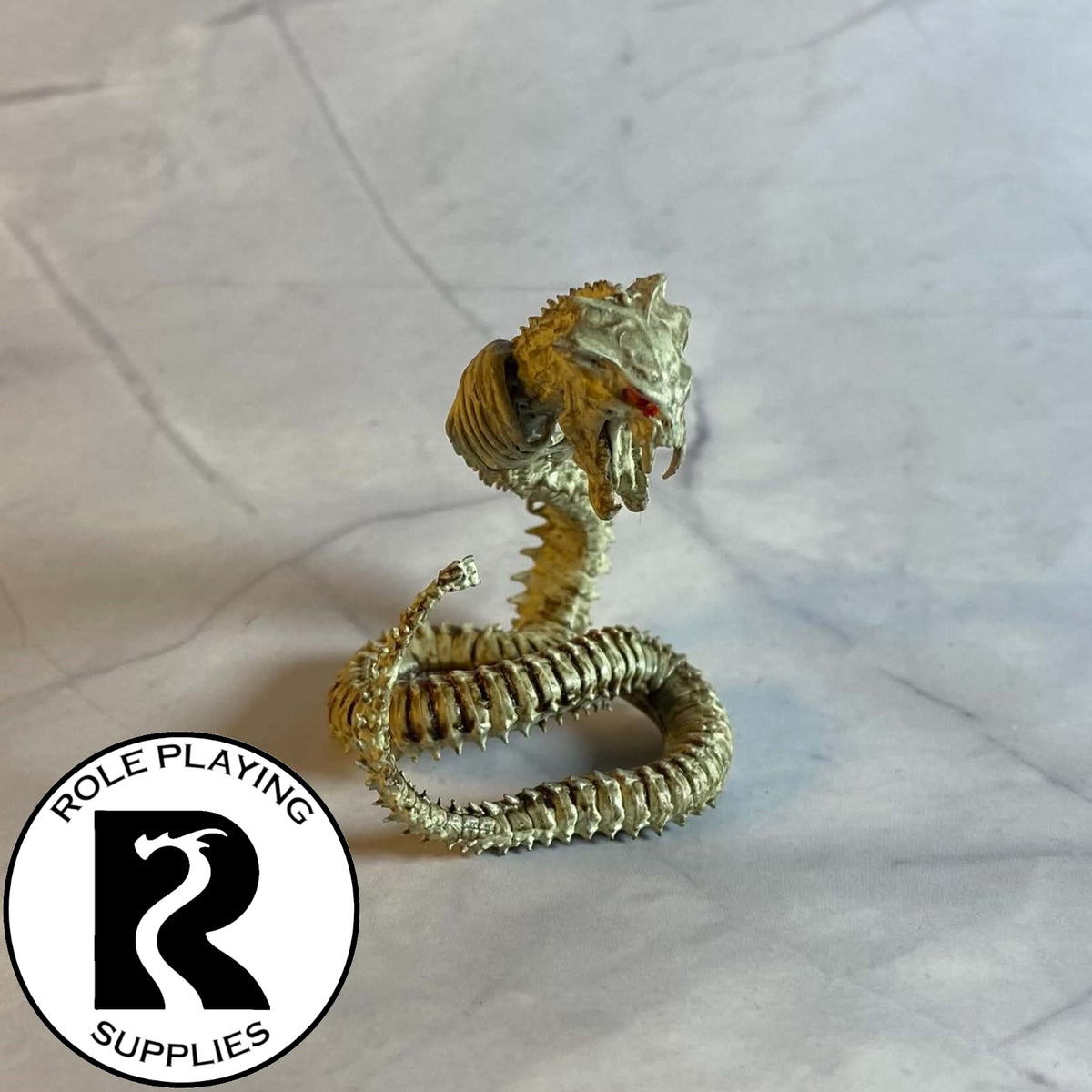 A dnd miniature bone naga painted 28mm scale.