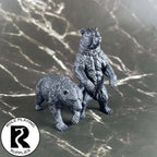 A dnd miniature brown bear primed in black.

