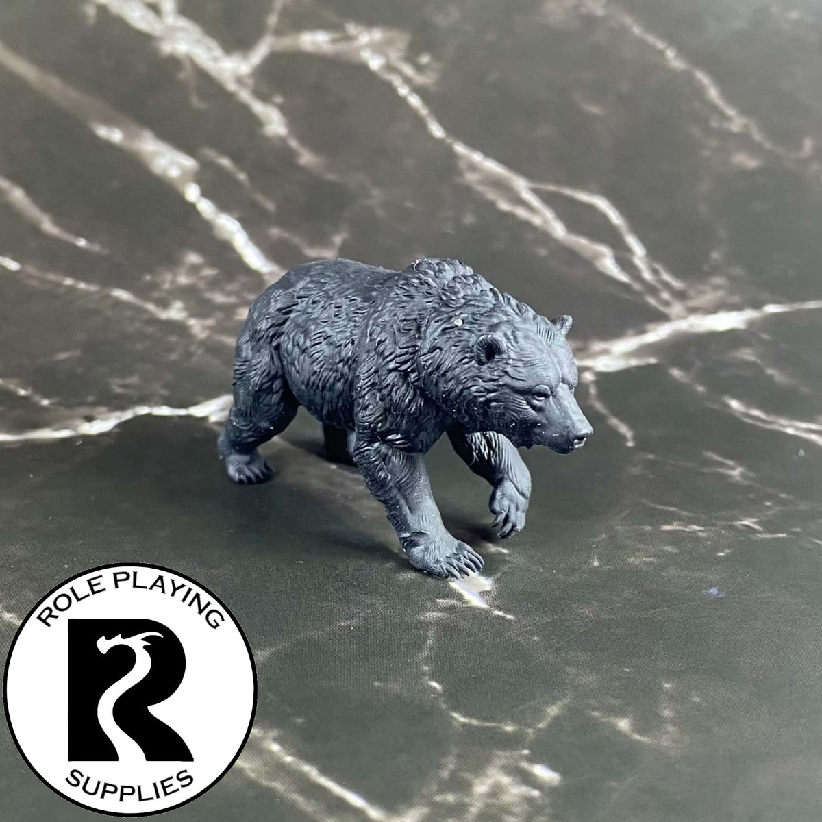 A dnd miniature brown bear primed in black.
