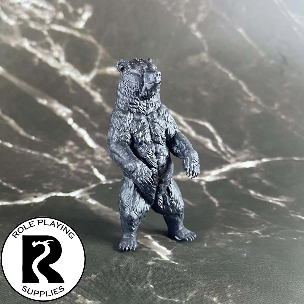 A dnd miniature brown bear primed in black.
