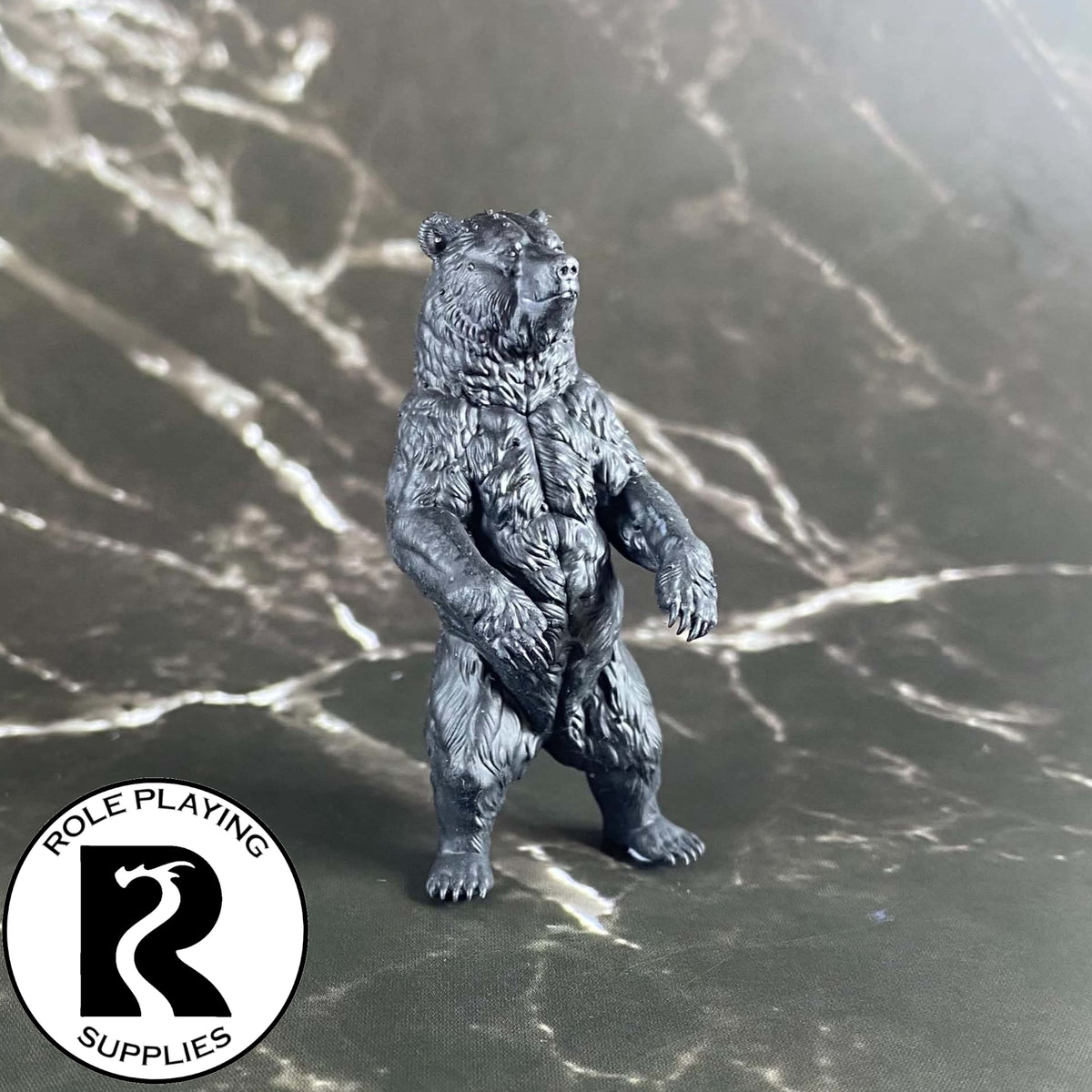 A dnd miniature brown bear primed in black.
