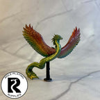 A dnd miniature couatl painted.
