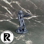 A dnd miniature dryad primed in black.
