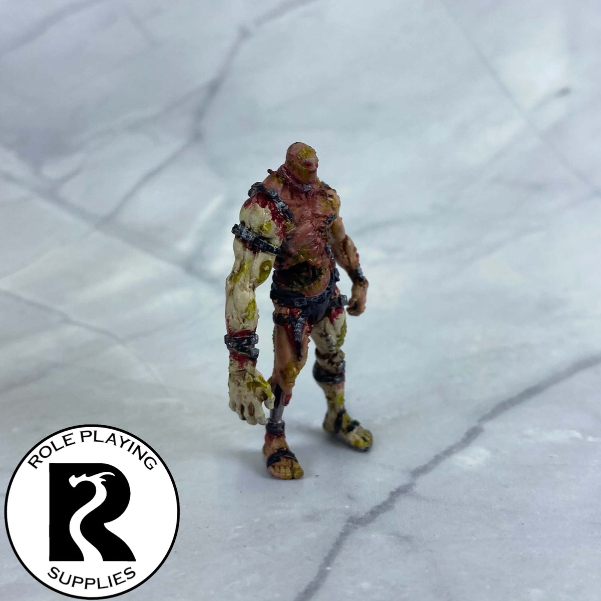 A dnd miniature flesh golem painted.
