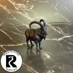 A dnd miniature giant goat primed in black.