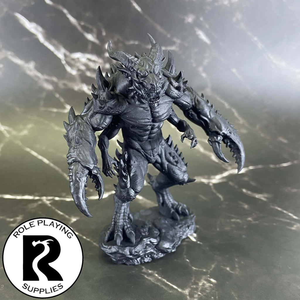A dnd miniature glabrezu primed in black.
