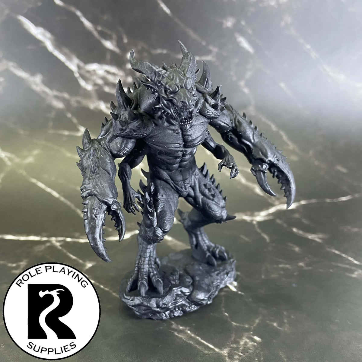 A dnd miniature glabrezu primed in black.
