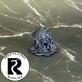 A dnd miniature gray ooze primed in black.
