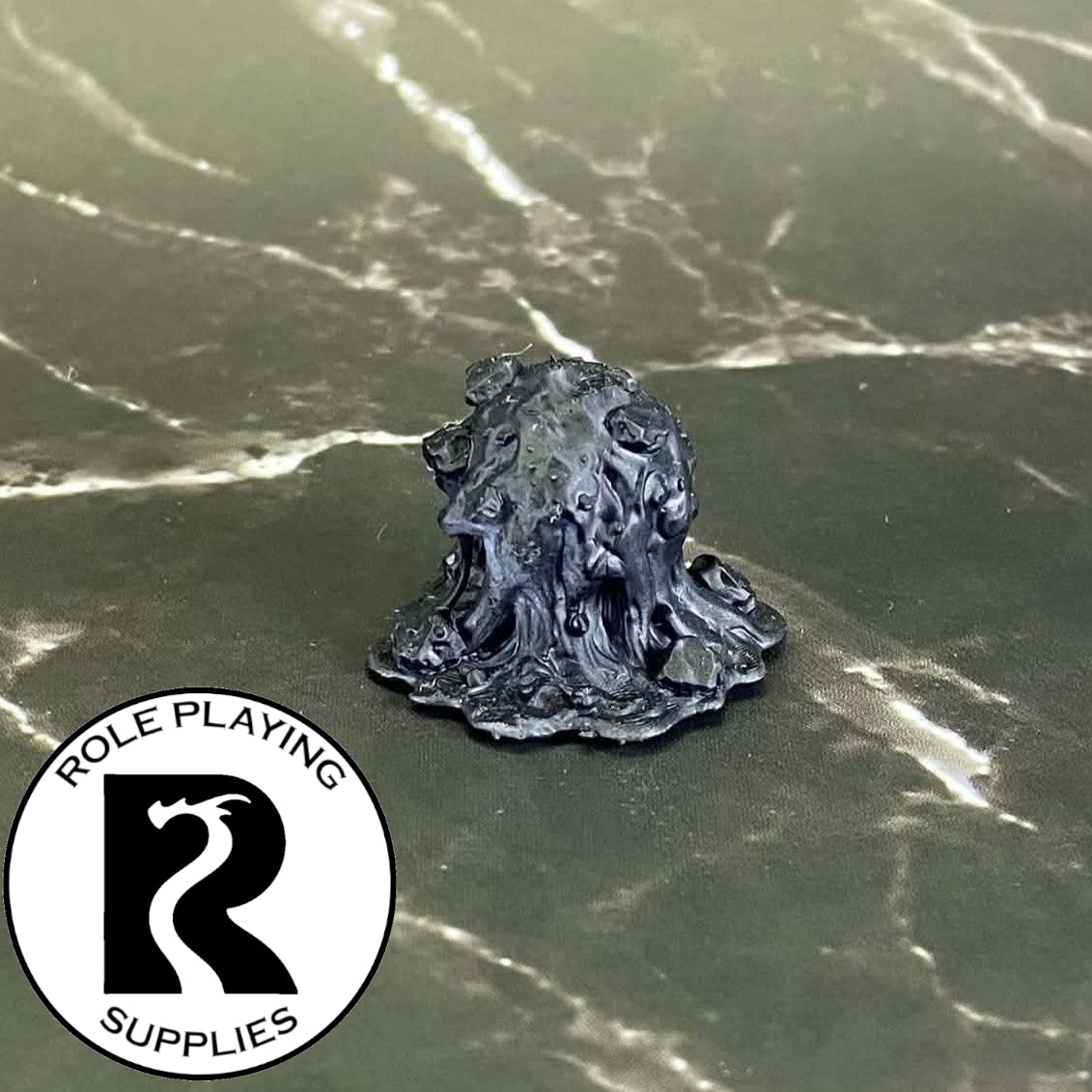 A dnd miniature gray ooze primed in black.

