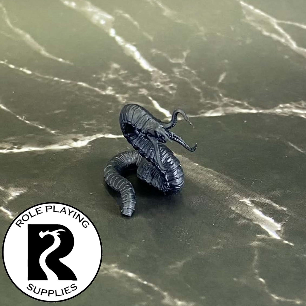 A dnd miniature grick primed in black.

