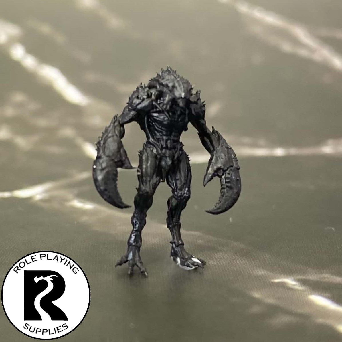 A dnd miniature meenlock primed in black.
