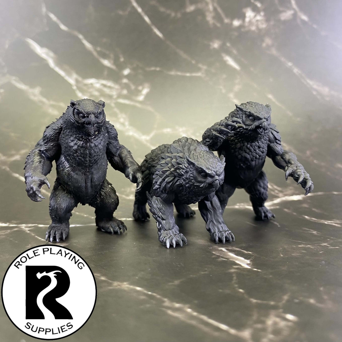 A dnd miniature owlbear primed in black.
