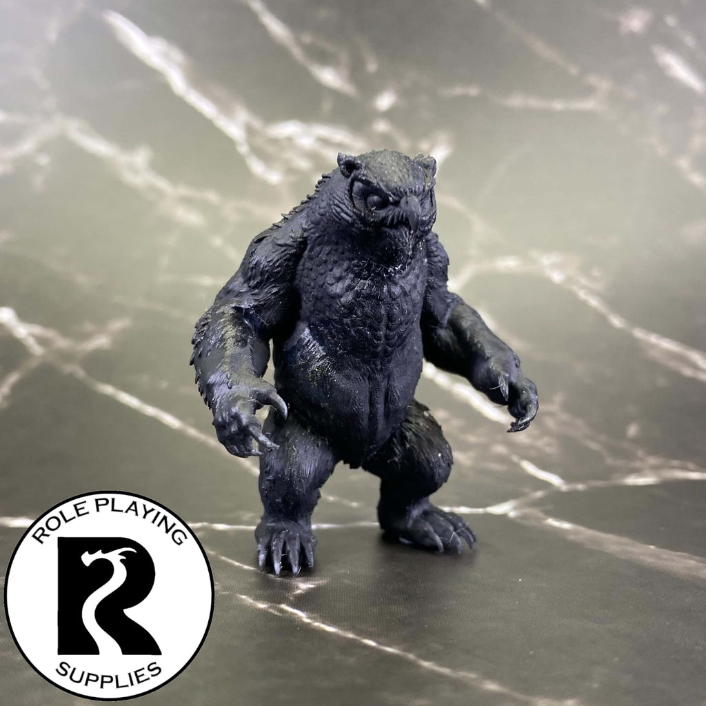 A dnd miniature owlbear primed in black.
