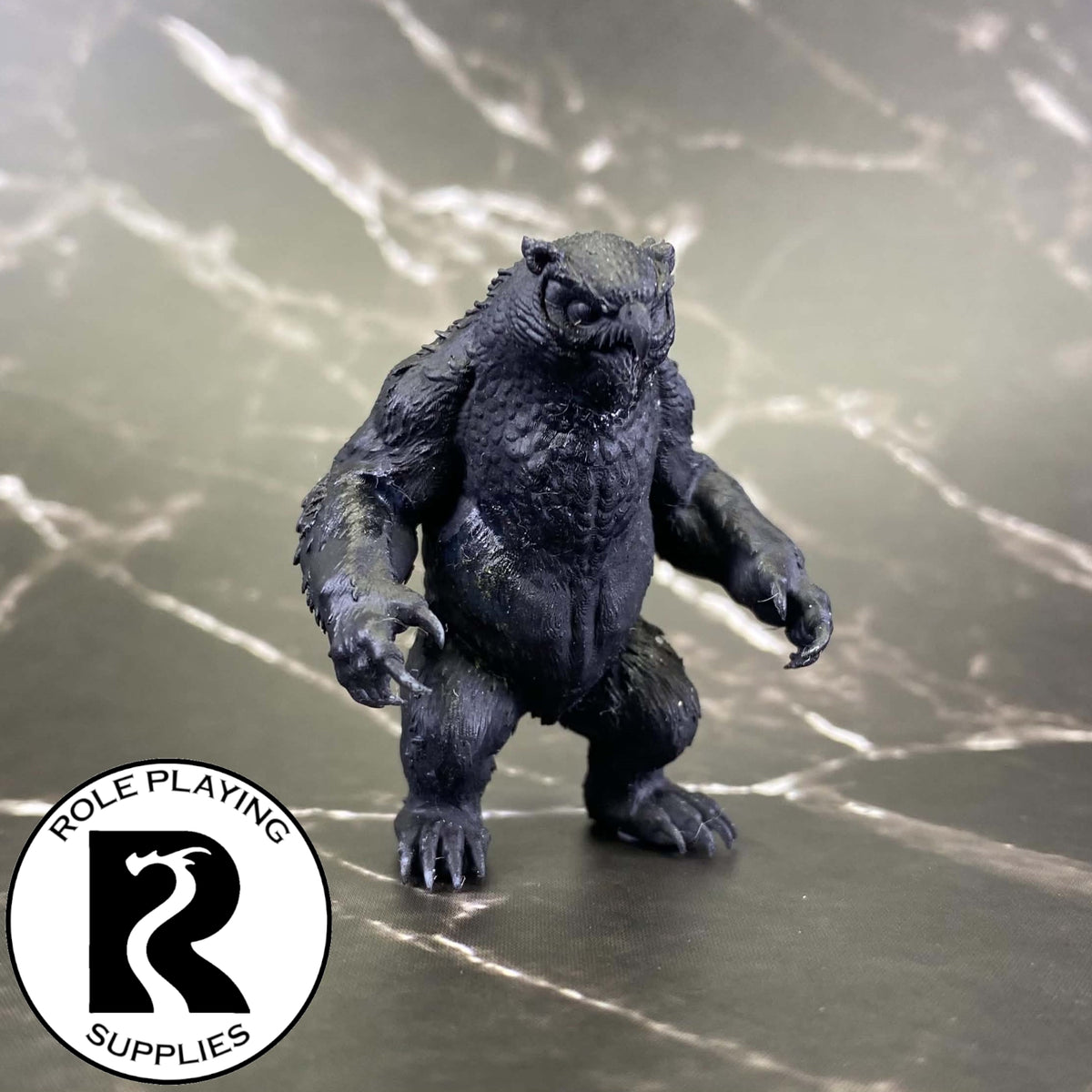A dnd miniature owlbear primed in black.
