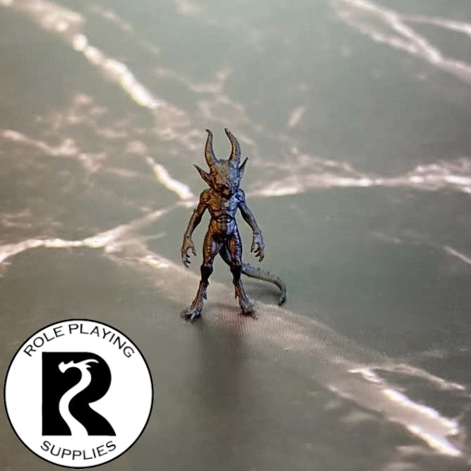 A dnd miniature quasit primed in black.
