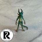 A dnd miniature quasit painted.
