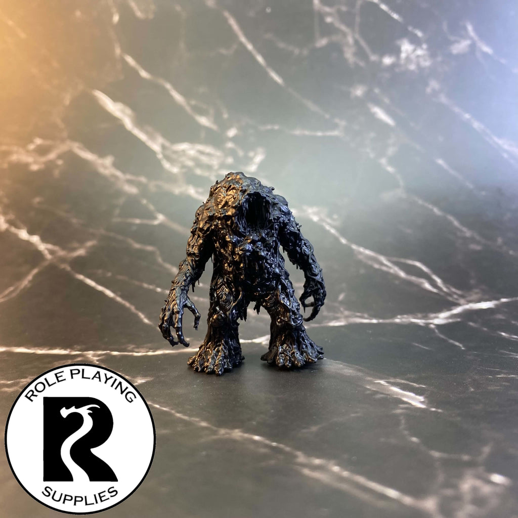 A dnd miniature shambling mound primed in black.
