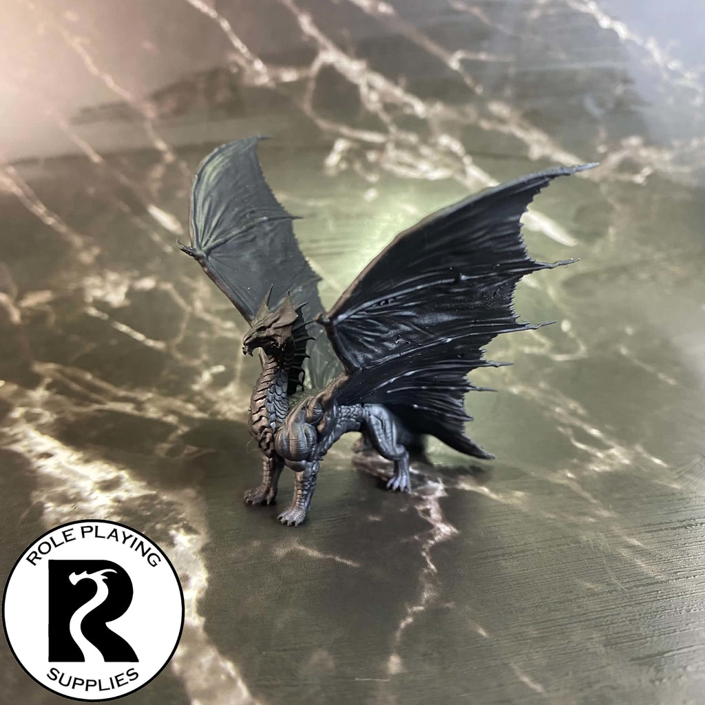 A dnd miniature young brass dragon primed in black.
