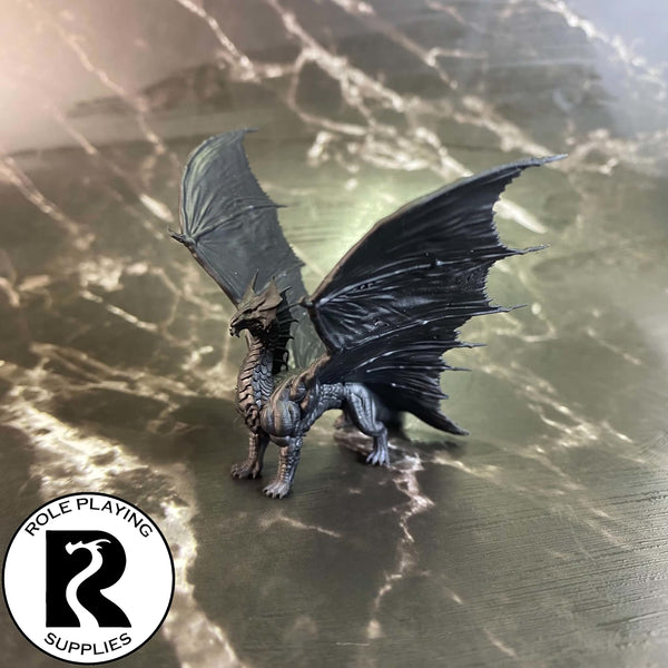 A dnd miniature young brass dragon primed in black.
